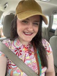 a woman wearing a hat in a car